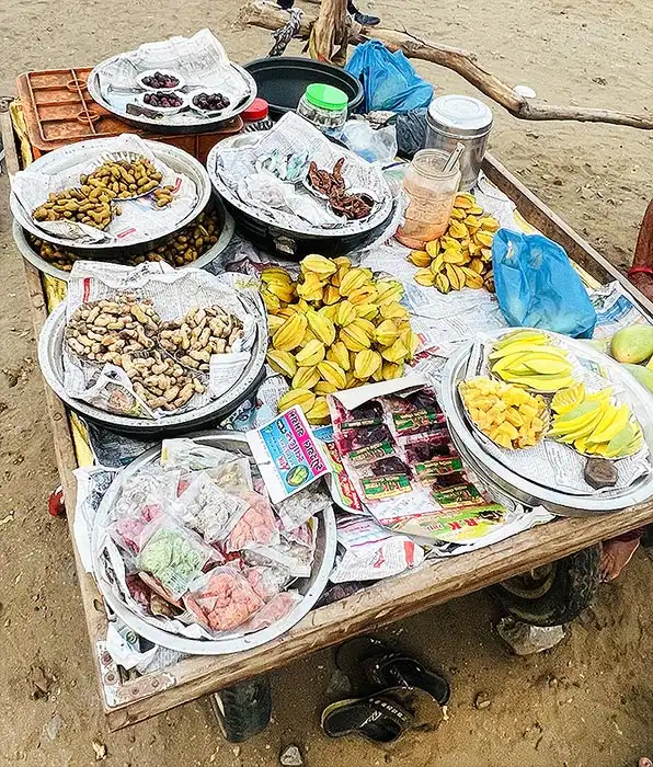 Street food cart with raw mango peanuts jamun and snacks at Dumas Beach Surat Gujarat