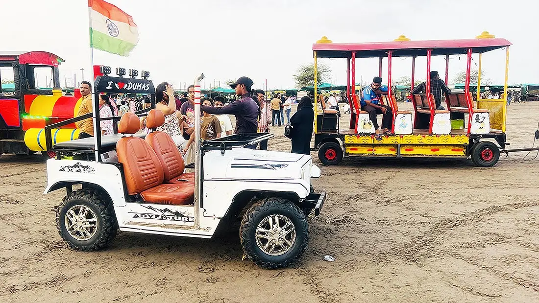 White jeep ride booking at Dumas Beach Surat with visitors enquiring