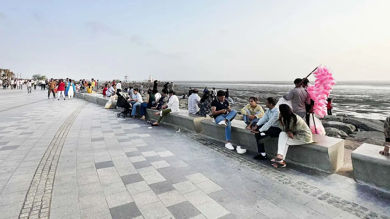 New Dumas Sea Face promenade with people relaxing by the sea in Surat