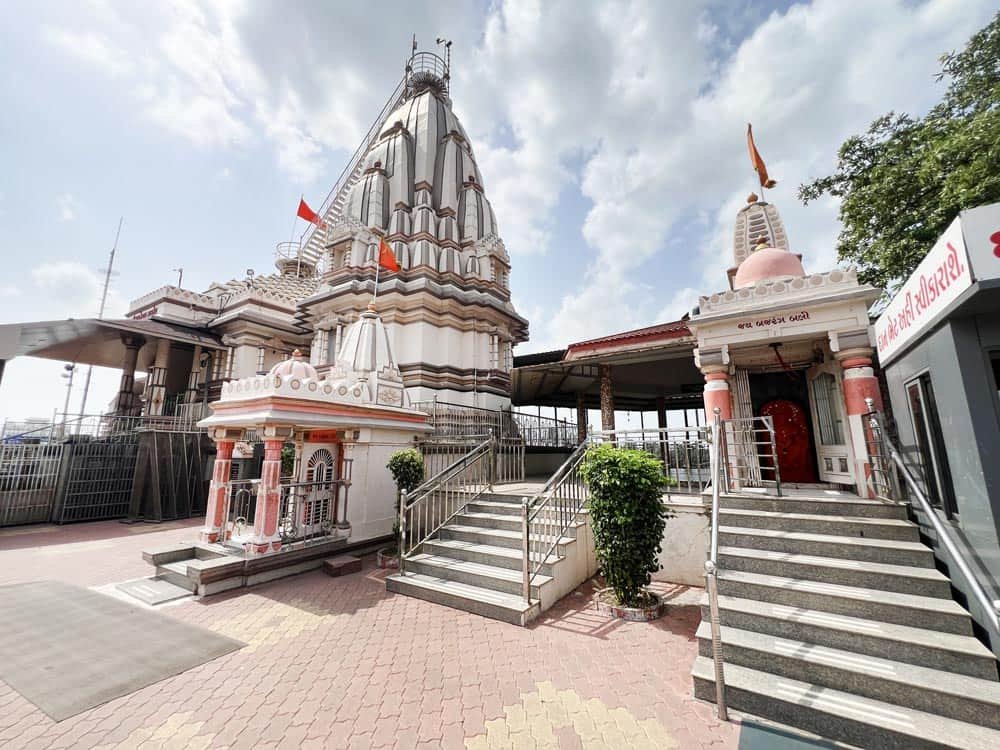 Small white shikhara-style shrines with staircases inside Galteshwar Mahadev Temple complex