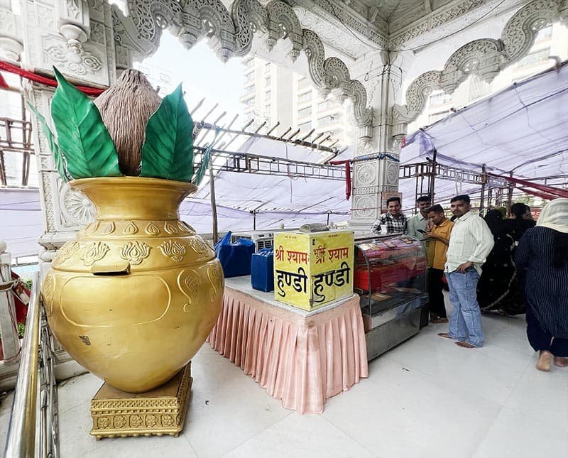 Large golden kalash with coconut and leaves at Khatu Shyam Mandir Surat