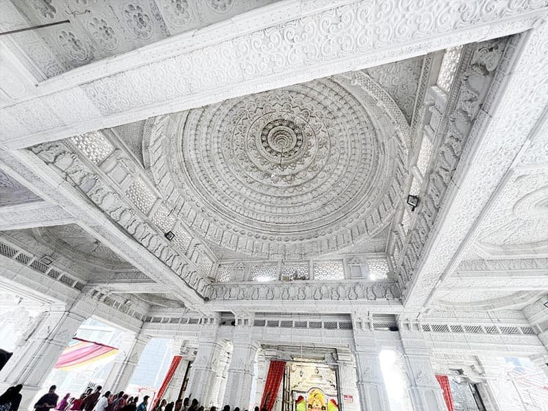 Intricate white marble dome ceiling carving inside Khatu Shyam Mandir Vesu Surat
