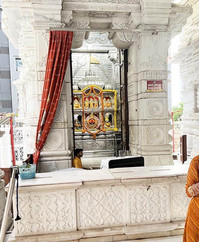 Silver decorated sanctum entrance with priest at Khatu Shyam Mandir Surat