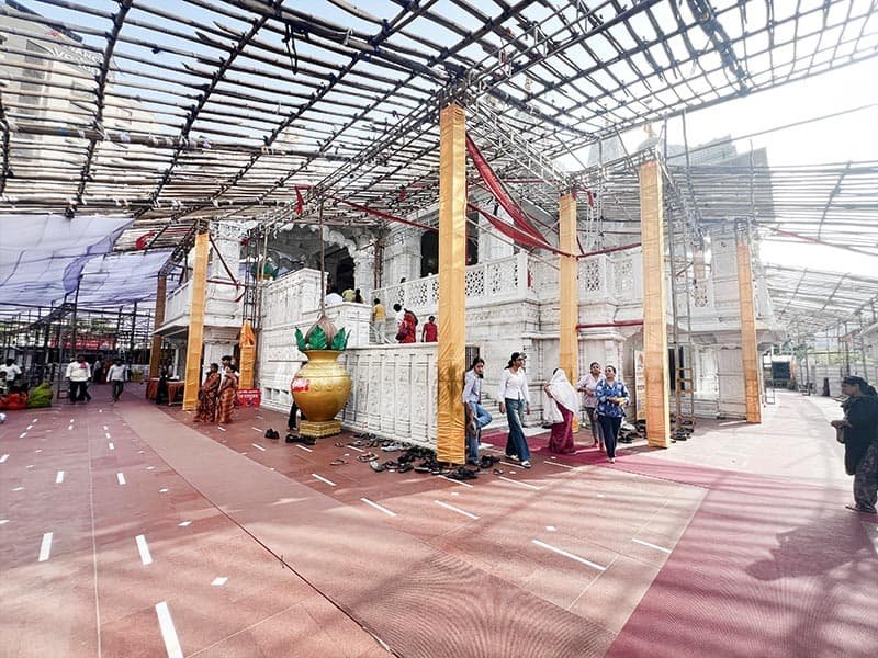 Courtyard view around Shree Shyam Baba Mandir Surat with devotees walking near the kalash